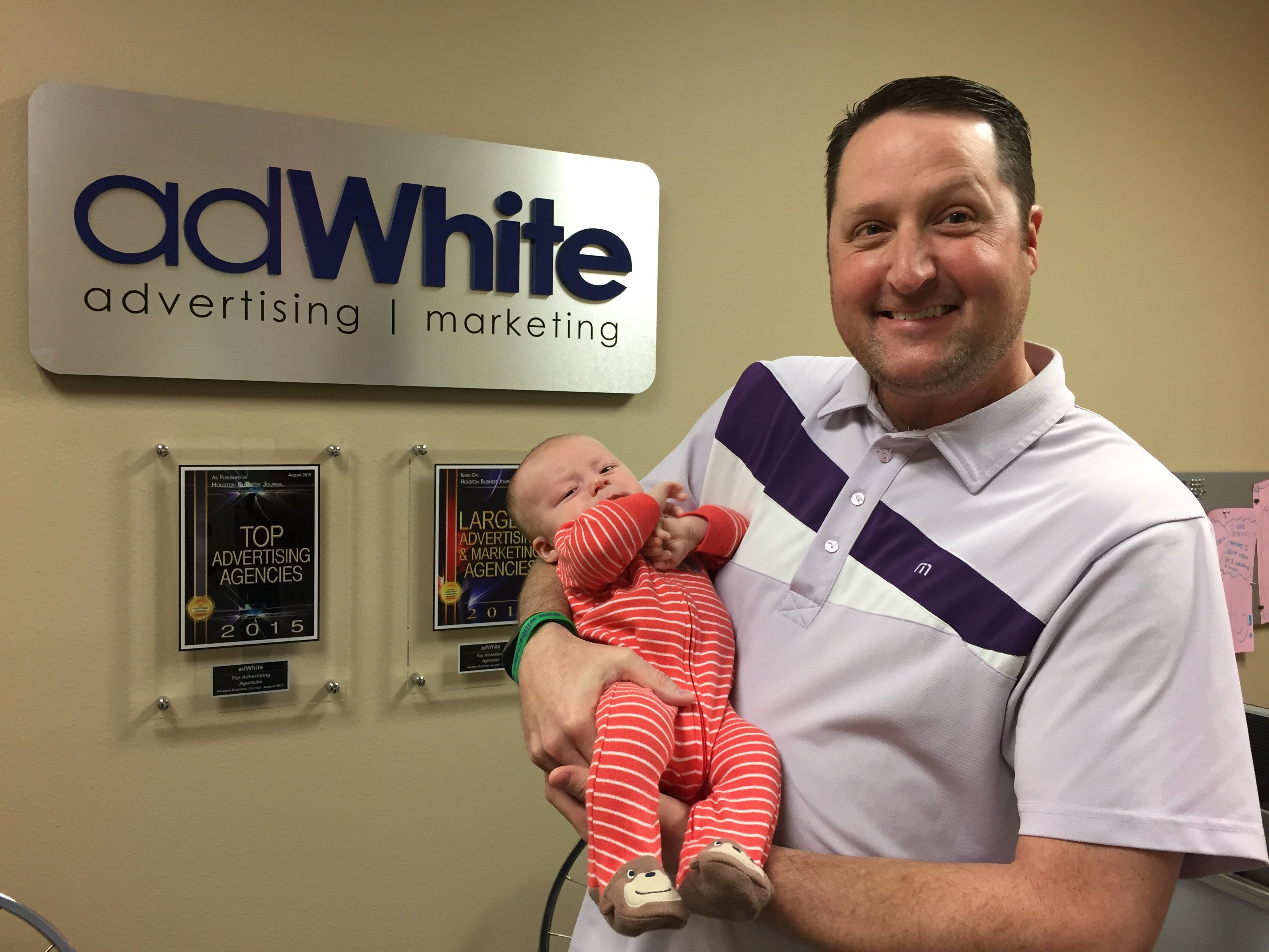 Taylor White holding a baby